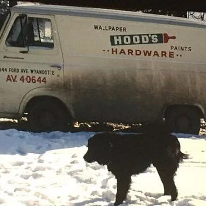 Dog in front of the Hood's Hardware van