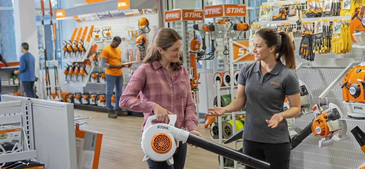 Employee demonstrating stihl equipment for customer