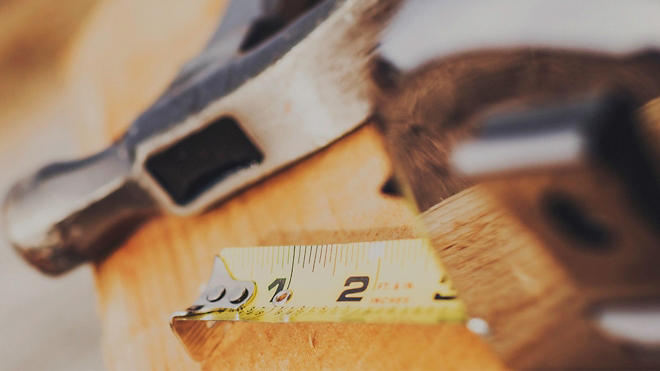 Image of a hammer and tape measure slightly blurred