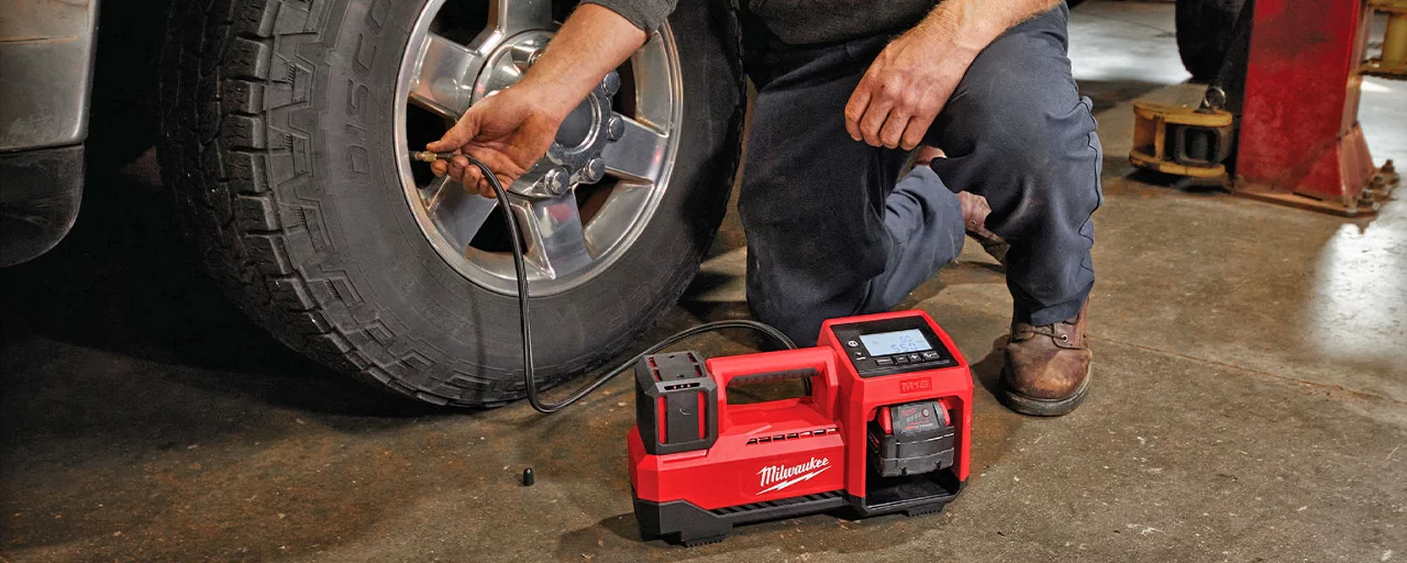 Milwaukee automotive air compressor pumping up a tire