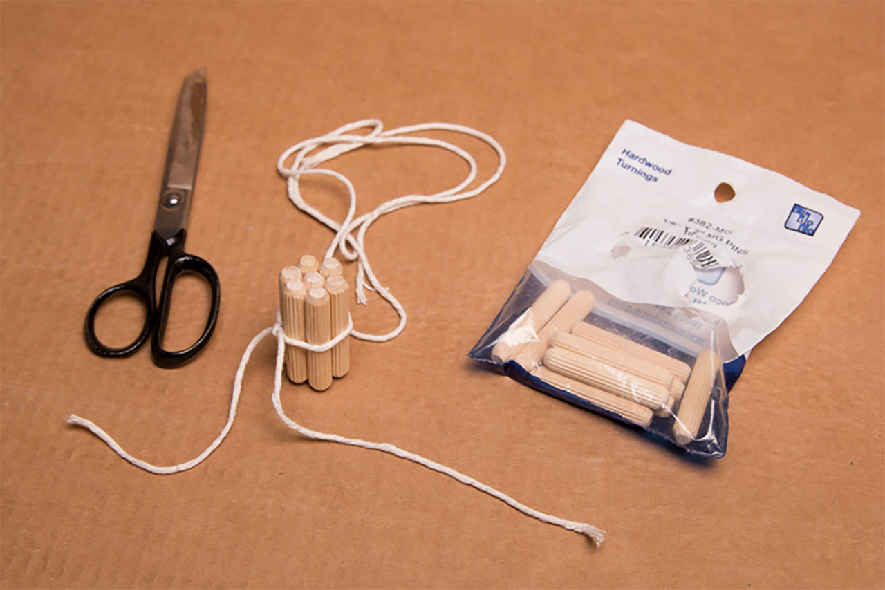 Materials for the pumpkin stem including twine, scissors, and dowels