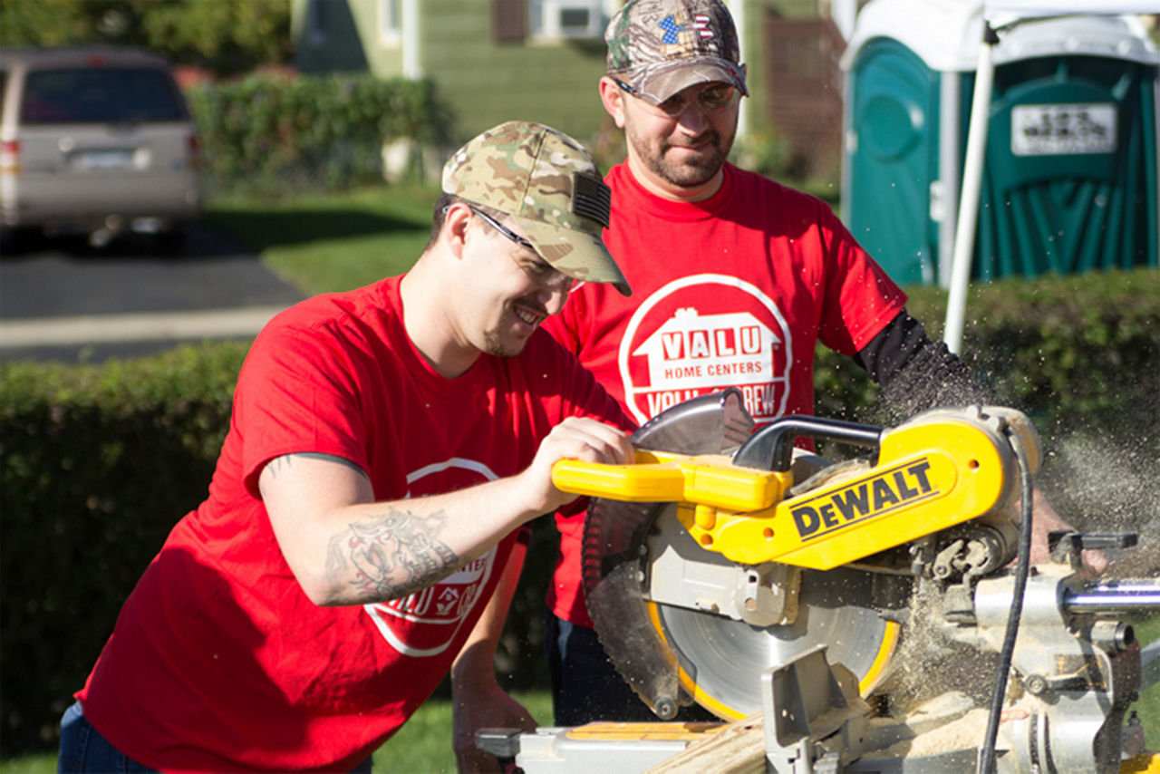 Man using dewalt tools to saw some wood for the house