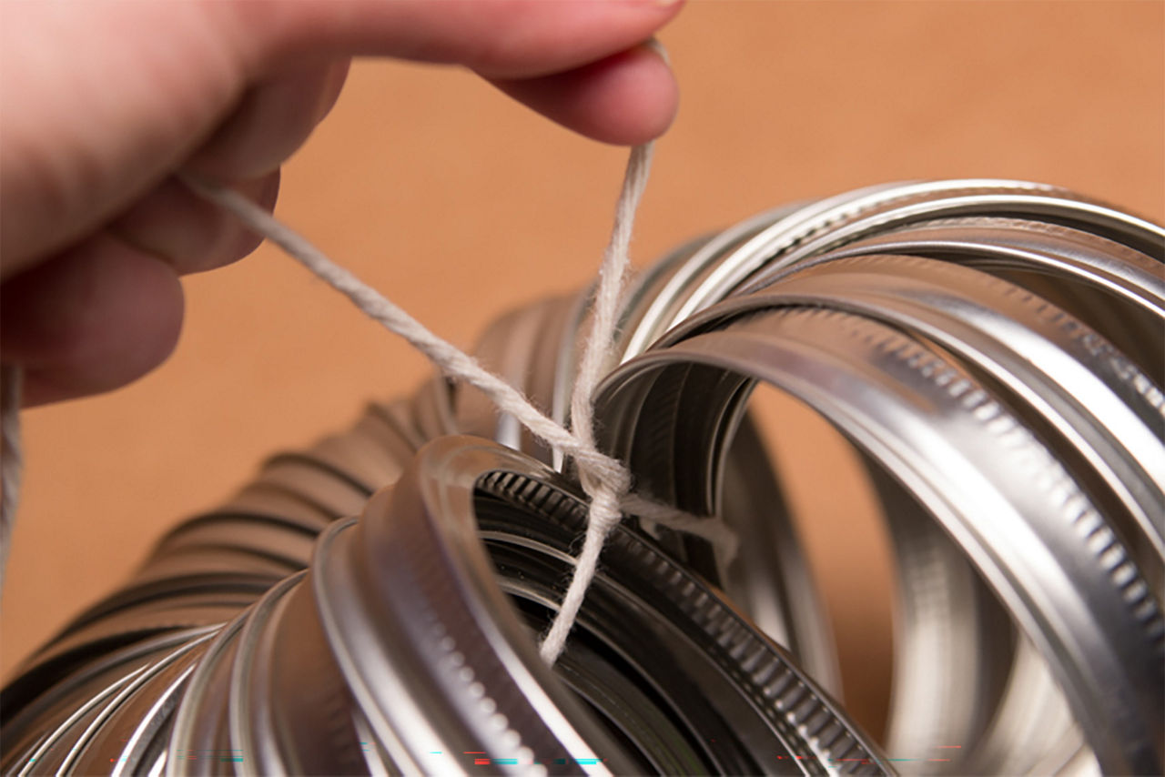 Tying the twine string in knot of the mason jar rings