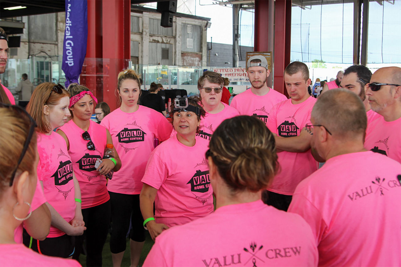 Group huddle with the valu crew in their pink shirts