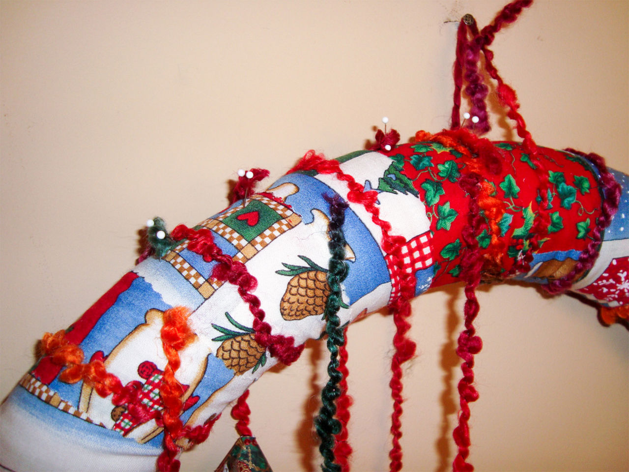 Close up of the pool noodle wreath with the yarn wrapped around it