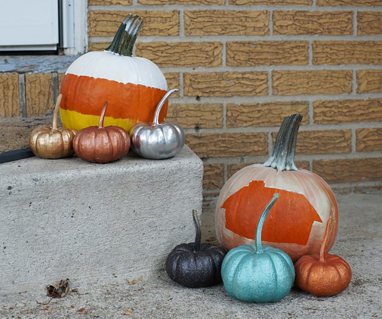 Photo with all of the different spray painted pumpkins