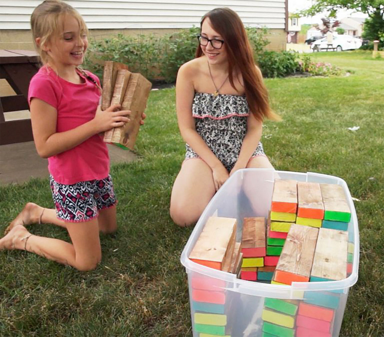 Girls putting away the giant jenga pieces