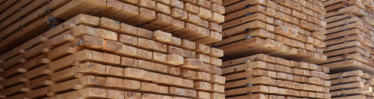 Stacks of treated lumber in a lumberyard