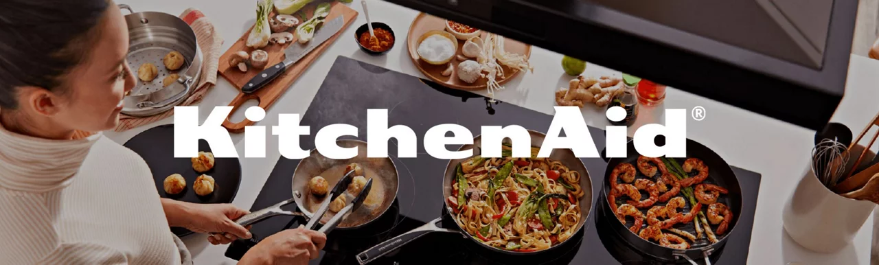 KitchenAid logo on top of a photo of a woman cooking with KitchenAid products 