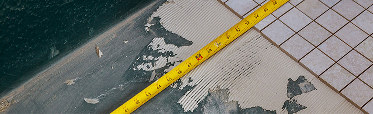 Tape measure on the bathroom floor to measure the space available