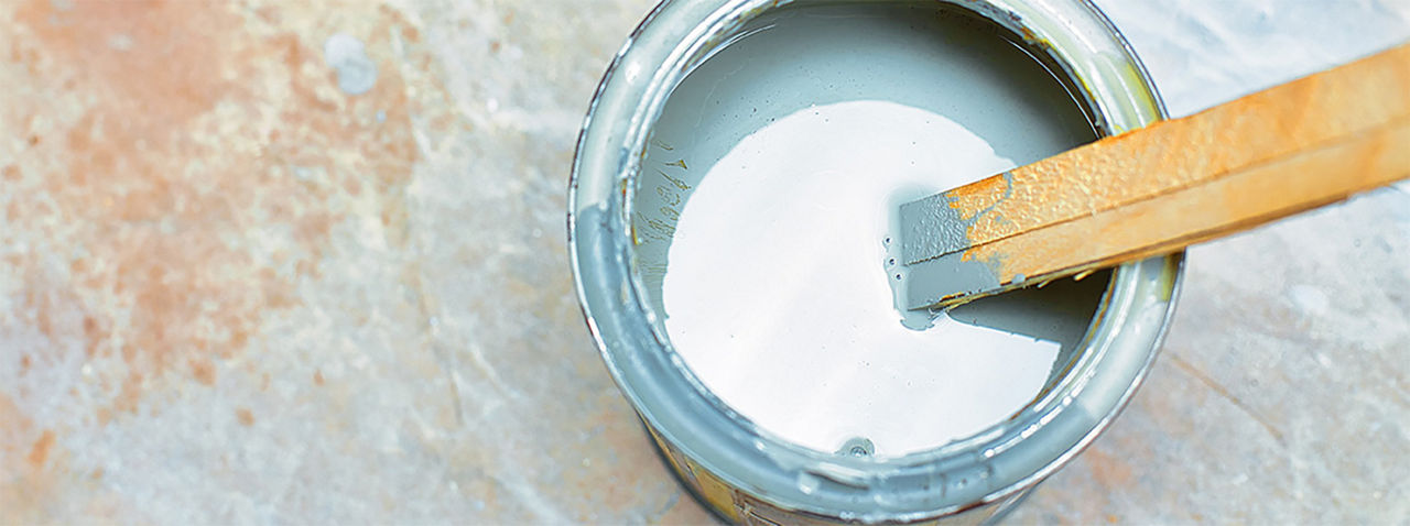 Paint stir stick in an open paint can