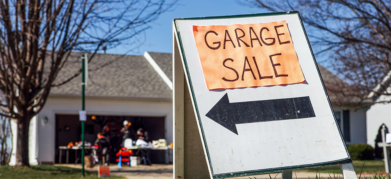 Garage sale sign in front of a house