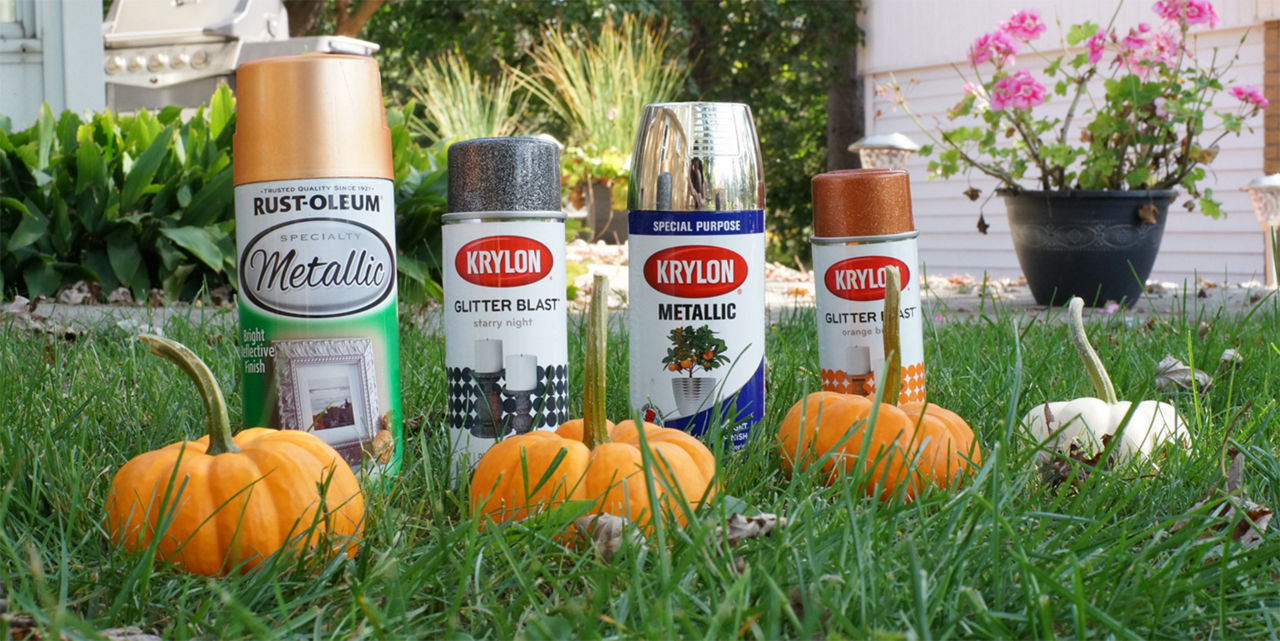 Metallic spray paint near pumpkins to get ready to paint them