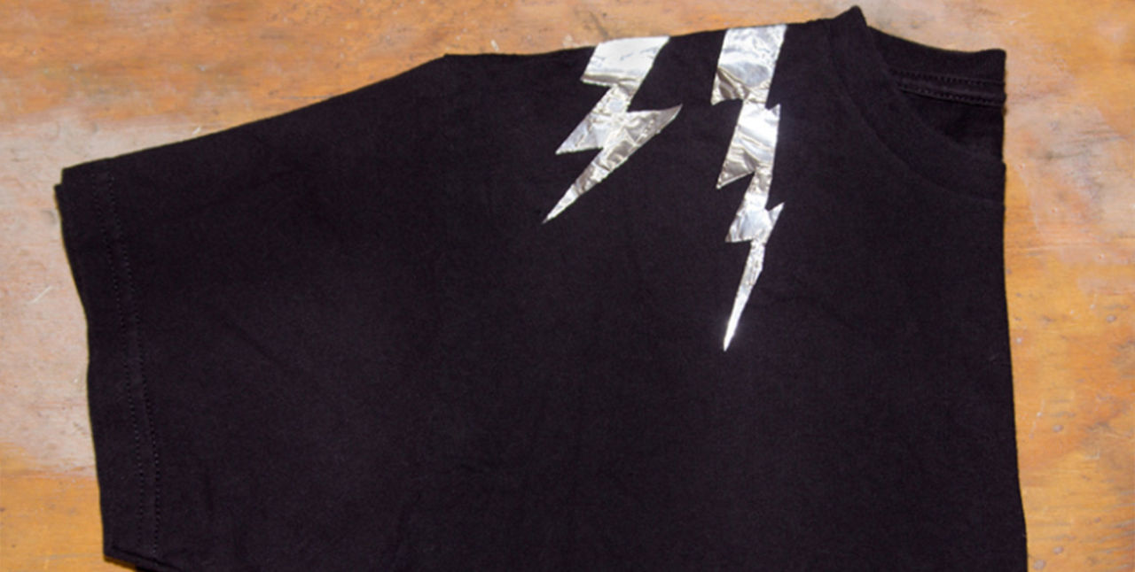 Black t-shirt with reflective duct tape in the shape of lightning bolts on the sholders 