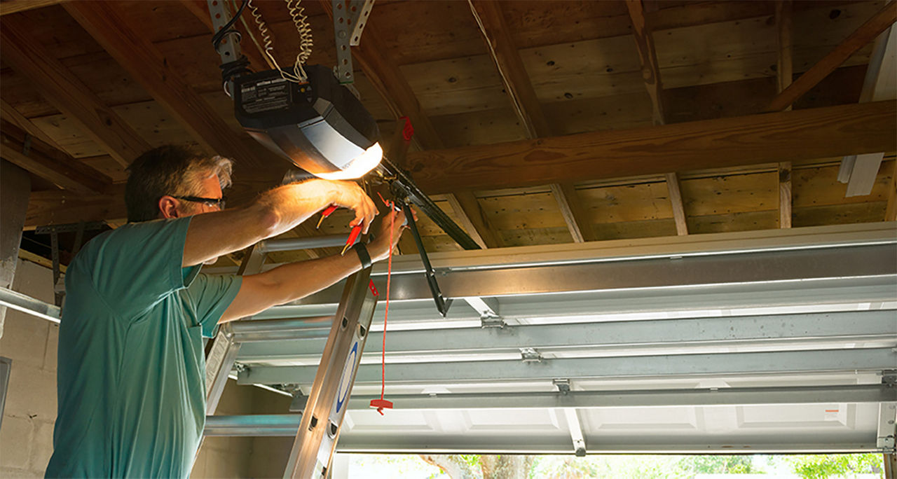 Guy repairing the garage door track