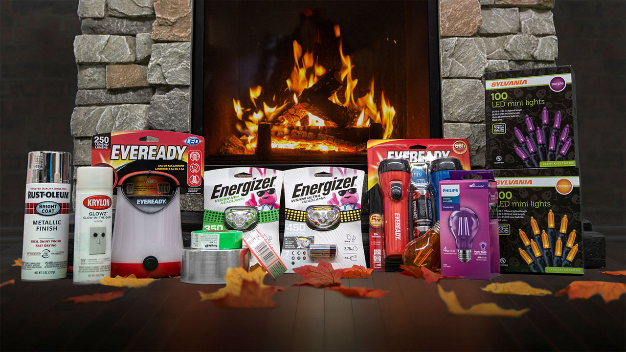 Halloween graphic with safety supplies such as a headlamp, lights, handwarmer, spray paint, leaves and a fire in the background