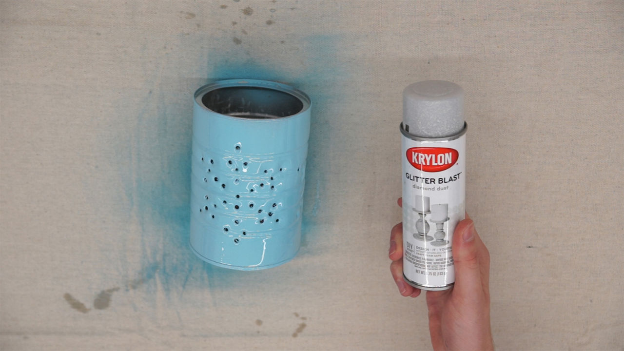 Krylon glitter next to the now blue tin can