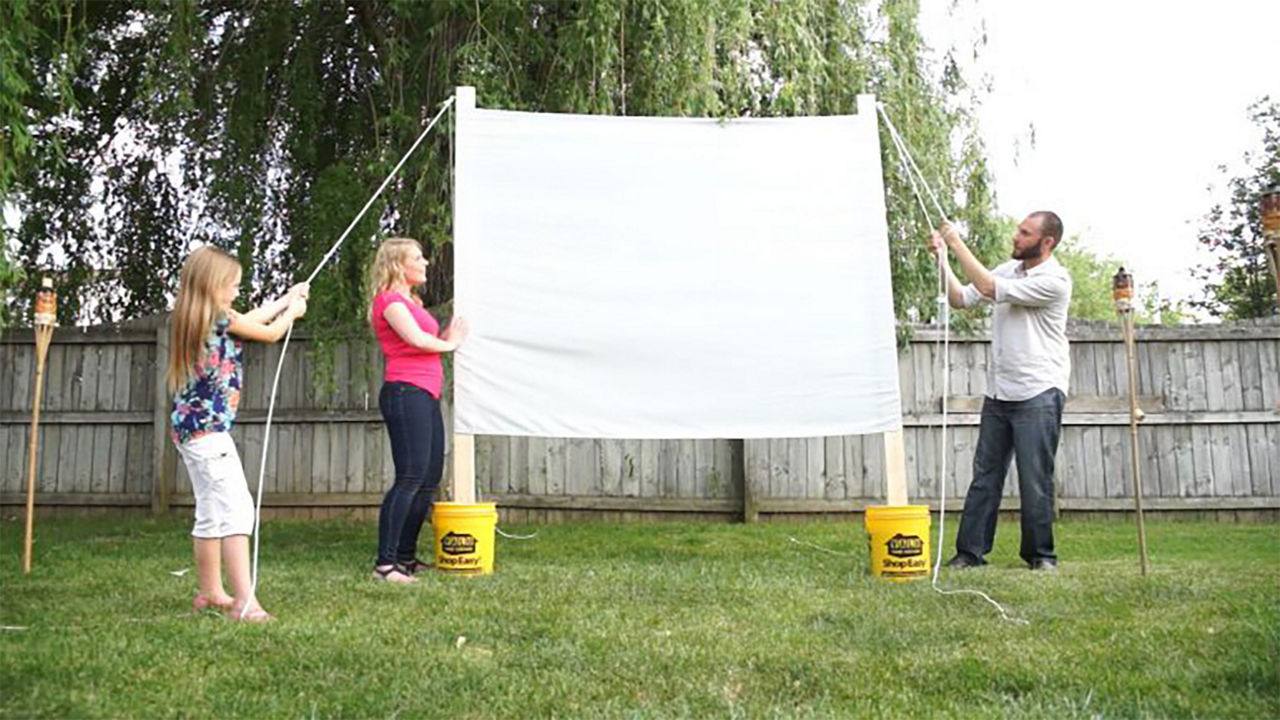 People pulling the screen for the projector