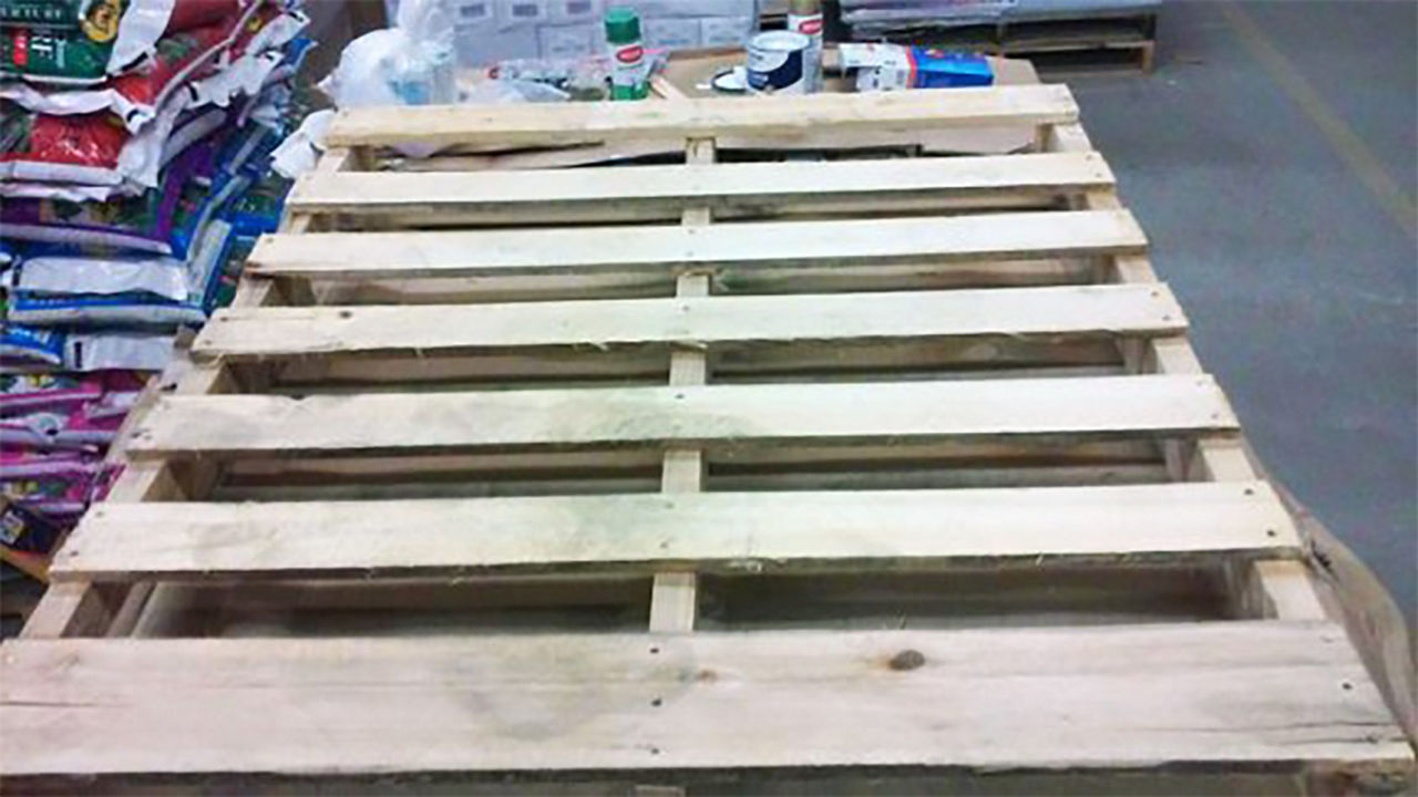 Sand your pallet to prep to paint the Christmas tree