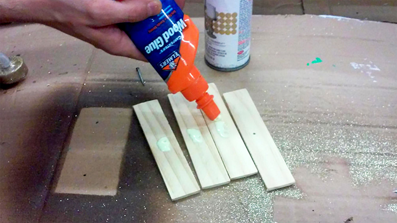 Adding wood glue on short wood sticks for the tree topper
