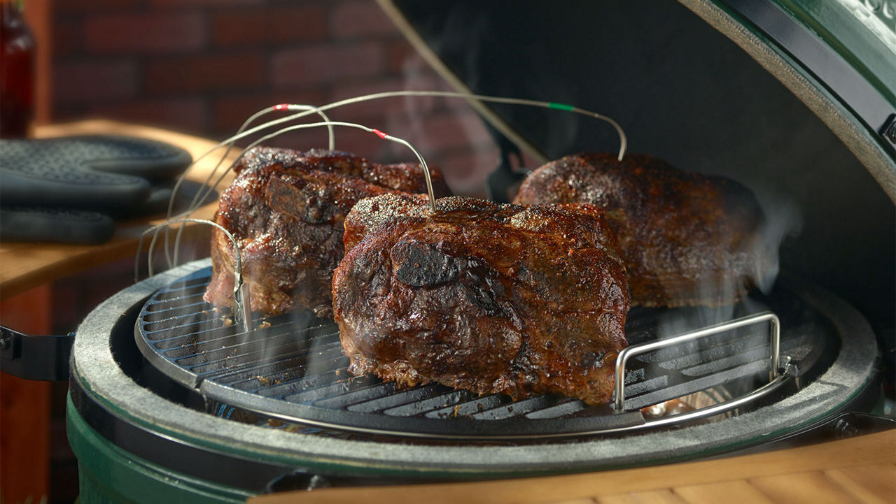 A close up of pork being grilled on a Big Green Egg