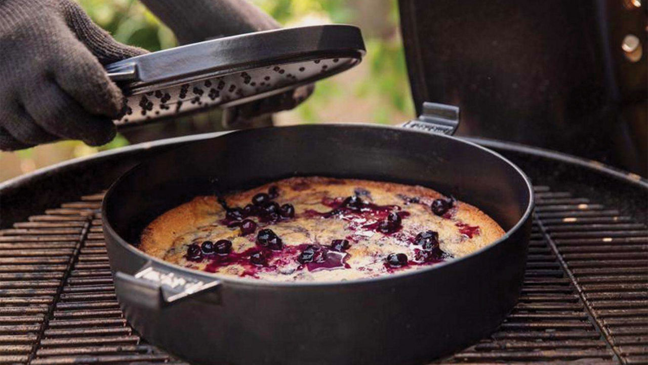 A pie being cooked on a grill