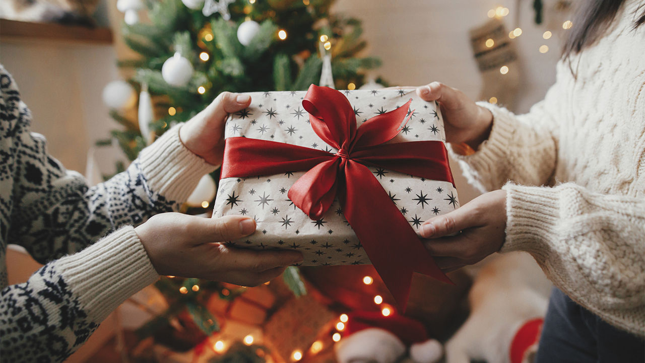 Two people exchanging gifts