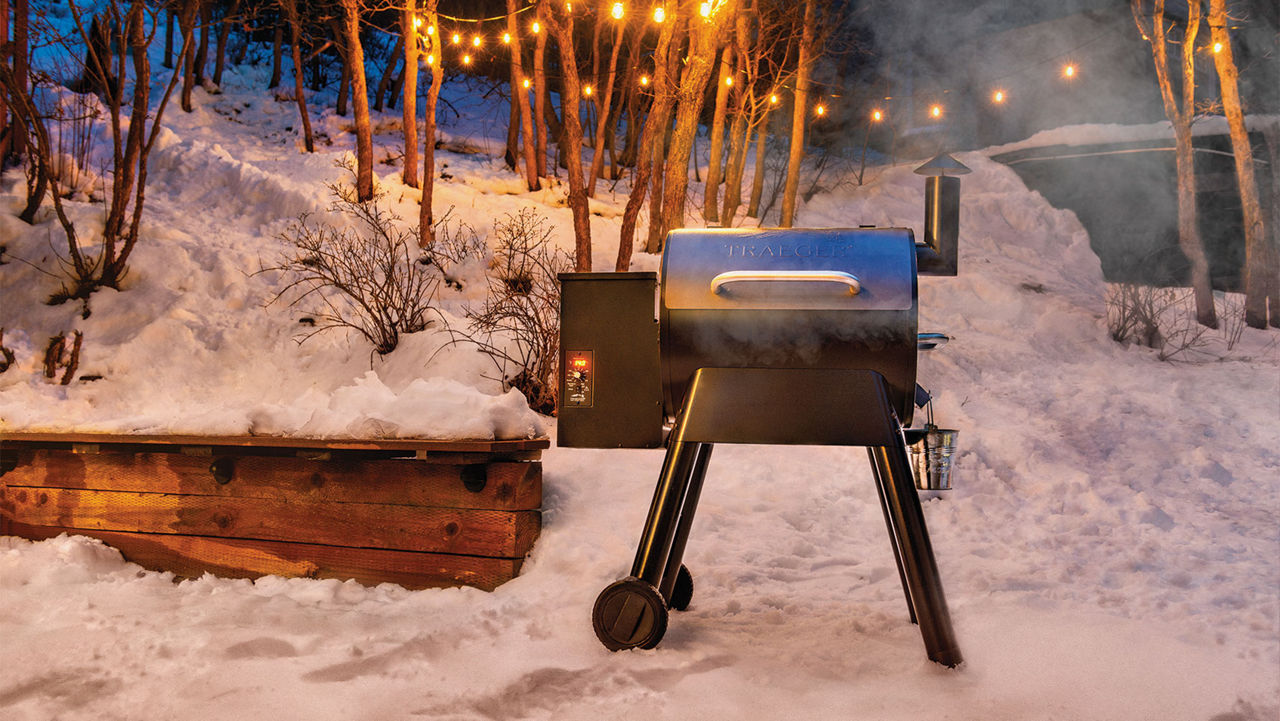 A Trager grill in a winter scene 