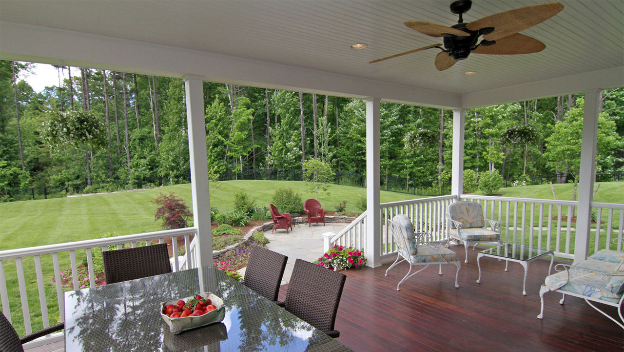 A ceiling fan hanging above an outdoor porch