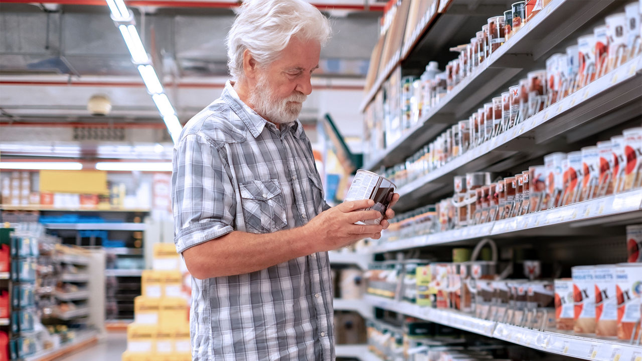 Man in a hardware store looking at paint options