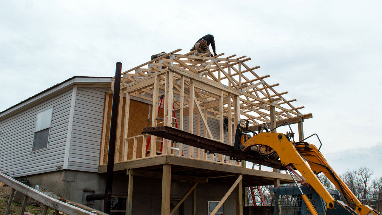 Construction workers adding a room on to a house