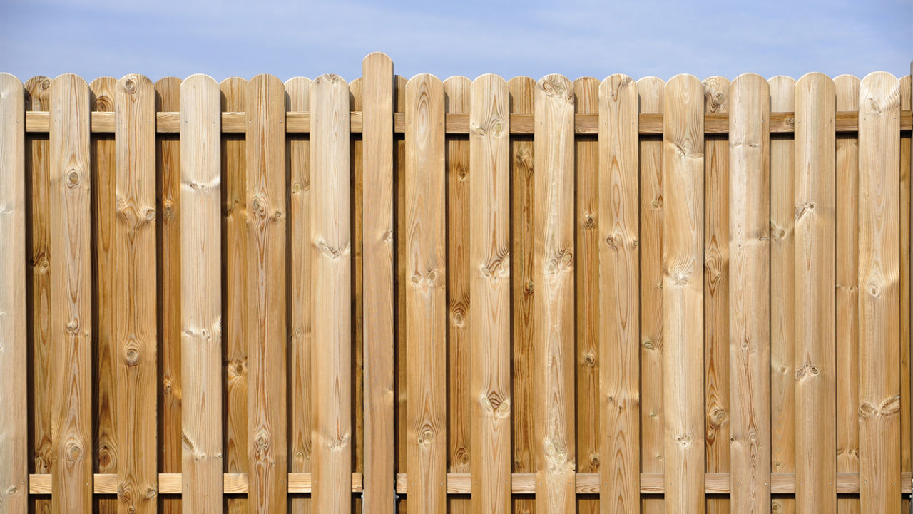 Wooden plank fencing and blue sky