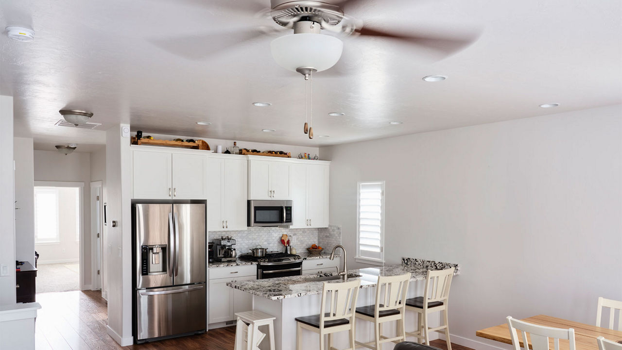 A ceiling fan hanging in a kitchen