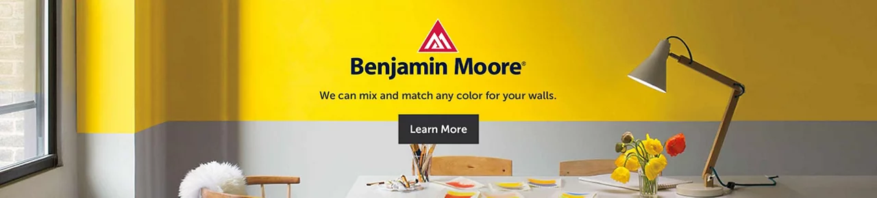 Benjamin Moore logo with a desk/work setting background