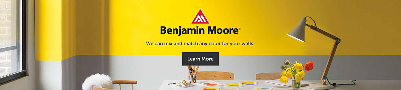 Benjamin Moore logo with a desk/work setting background
