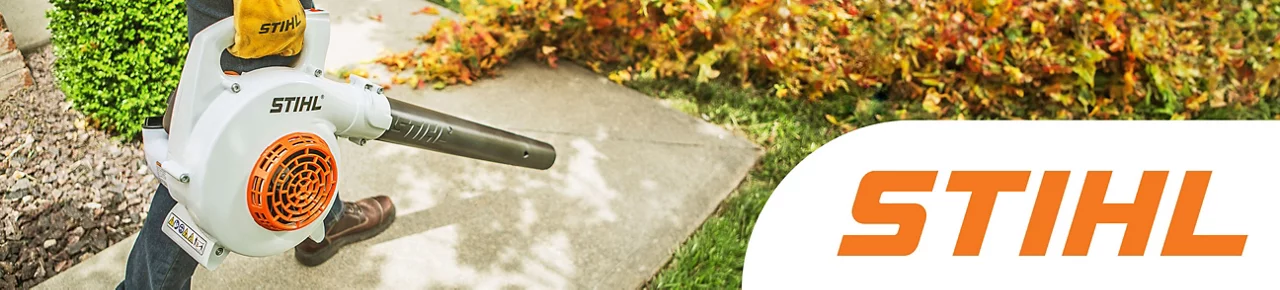 Stihl - Middle aged man using a STIHL gas powered blower to clear leaves off a sidewalk