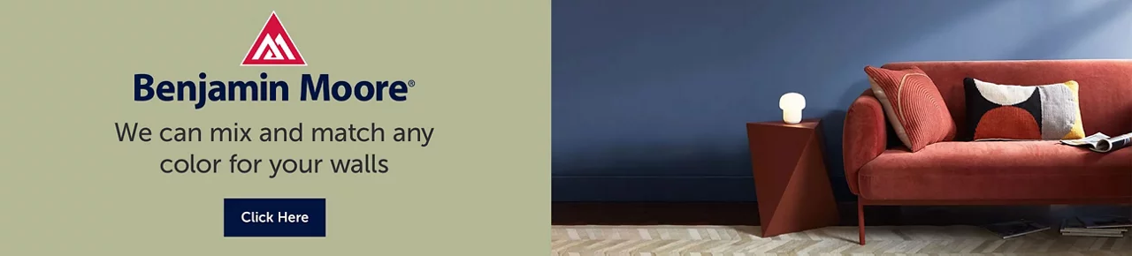 Text on the left, "Benjamin Moore. We can mix and match any color for your walls"" - Image on the right, Dark blue painted living room wall with a red couch and side table against it.