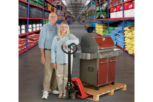 Norm and Linda from Eastwood Hardware standing with a grill