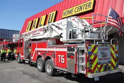 Firetruck parked in front of Valu Home Center with american flag