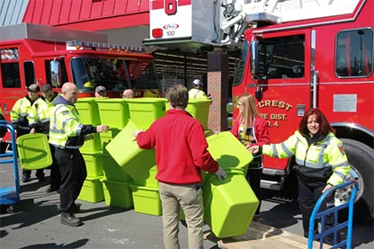 Firefighters loading and stacking storage totes