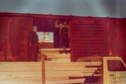 Richard Hochstein and John Everts unloading rail car of ponderosa pine lumber.