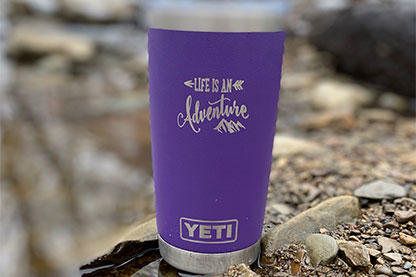 Purple YETI Tumbler with Life is an adventure engraved