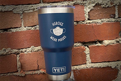 Navy blue YETi Tumbler with heroes wear masks engraved