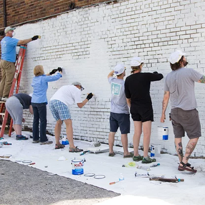 Participants filling in paint between the bricks