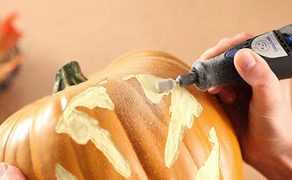 Using a dremmel tool to smooth out the pumpkin