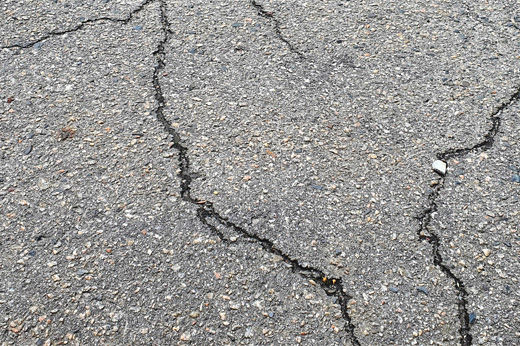 How to Repair Cracks in Your Asphalt or Concrete Driveway