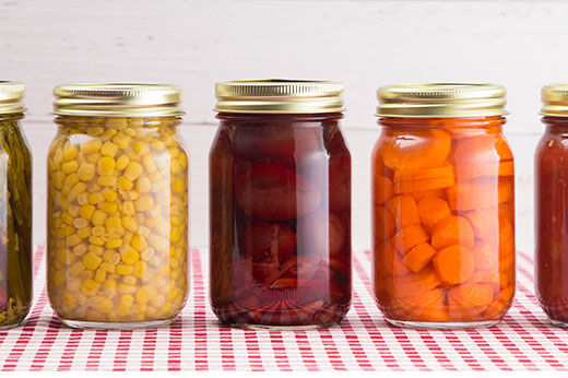 Jars lined up with preserved food