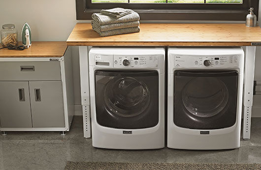 A laundry room with a white washer and dryer