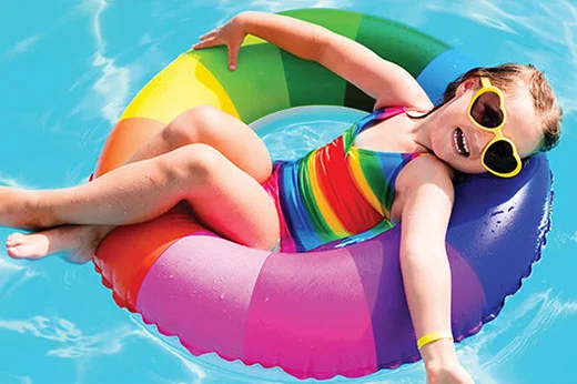 child on a float in a pool