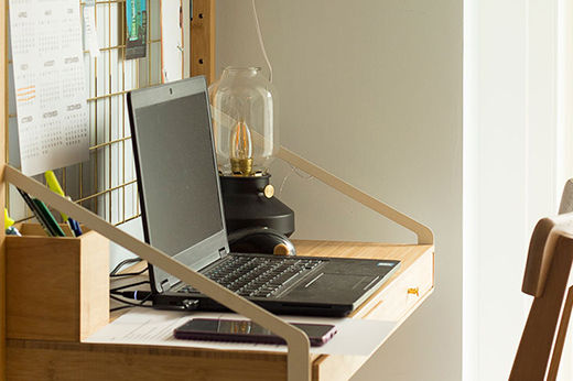 Laptop open on a space saving desk